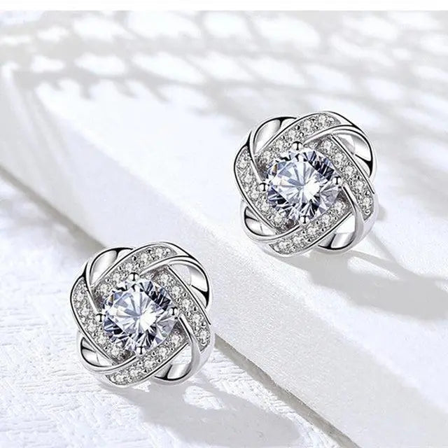 Boucles d'Oreilles Dorées en Spirale avec Fleur et Cristal